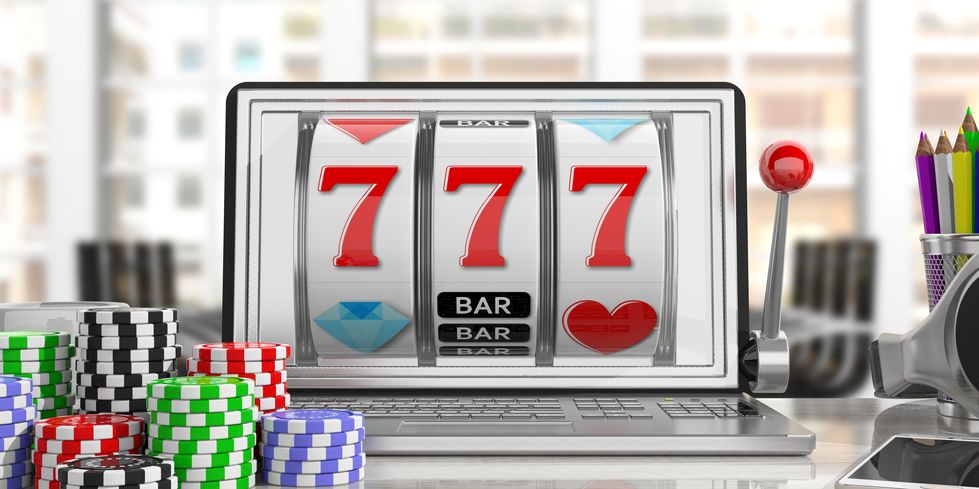 Slot machine on a laptop screen and poker chips