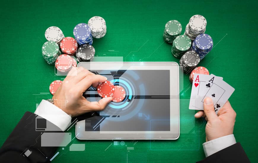 casino poker player with cards, tablet and chips